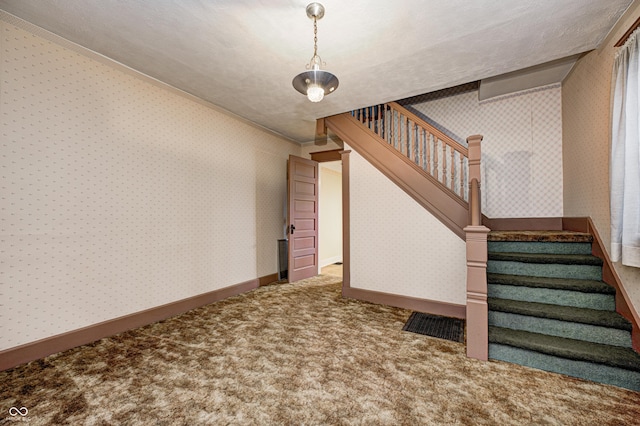 stairs featuring carpet floors and a textured ceiling