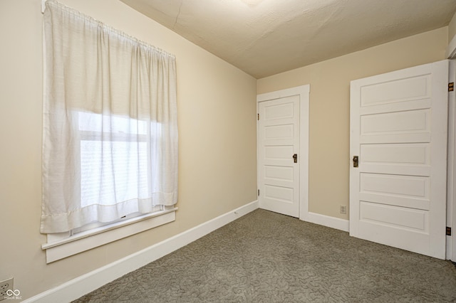 unfurnished bedroom featuring carpet flooring and a textured ceiling