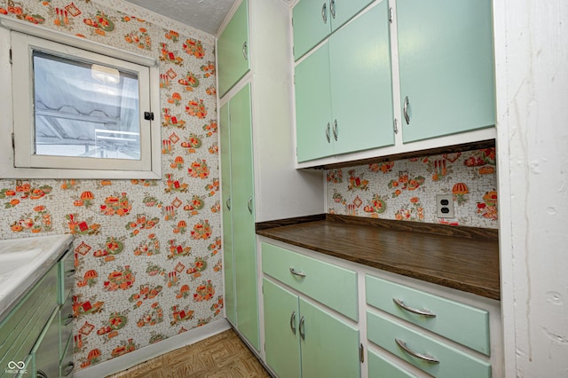 kitchen featuring dark parquet flooring and green cabinets