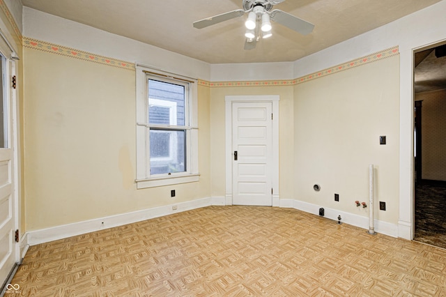 spare room with light parquet flooring and ceiling fan