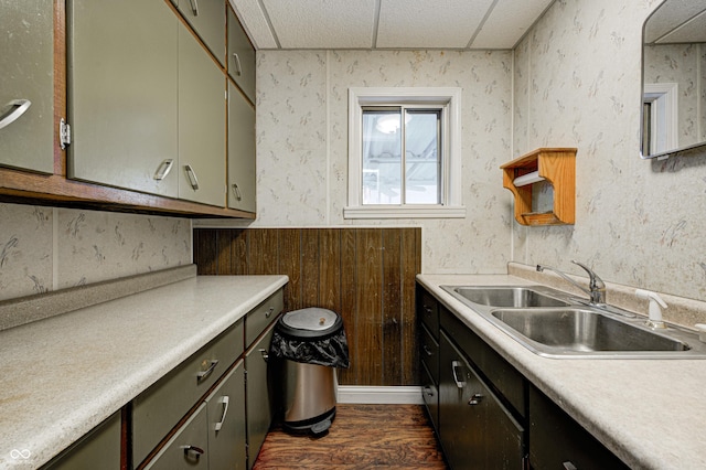 kitchen with a paneled ceiling, sink, and dark wood-type flooring