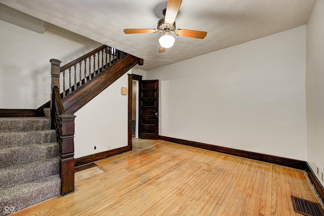 spare room with ceiling fan, light hardwood / wood-style floors, and lofted ceiling