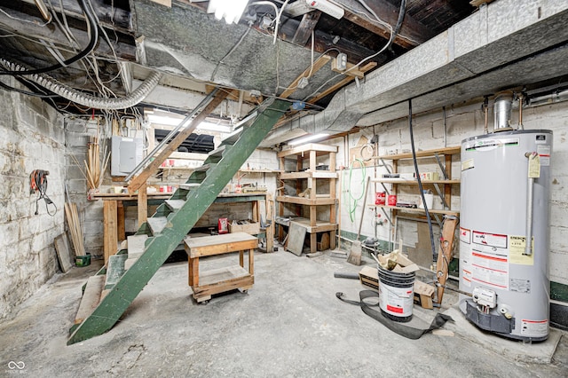 basement featuring electric panel and gas water heater