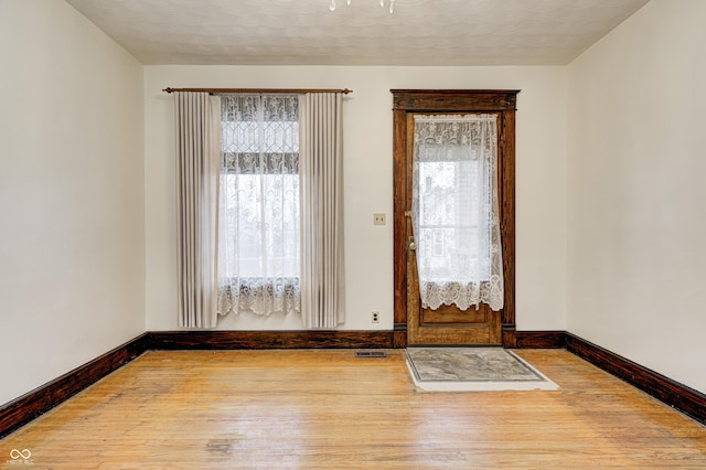 foyer with a textured ceiling and hardwood / wood-style flooring