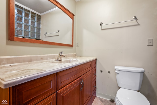 bathroom featuring ornamental molding, vanity, and toilet