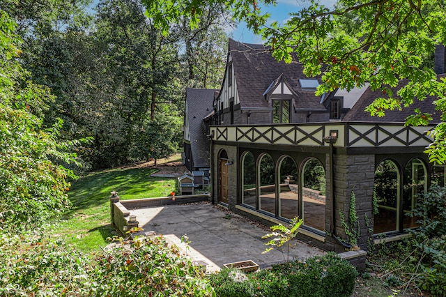 view of gate with a lawn