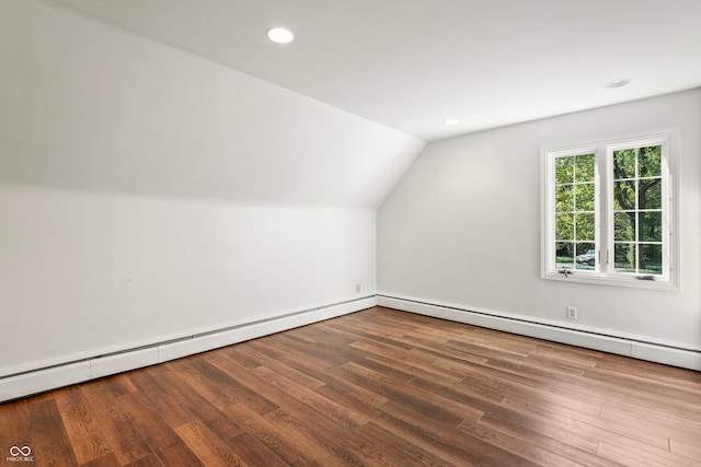 additional living space featuring wood-type flooring and lofted ceiling