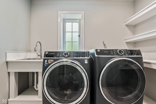 washroom with washer and clothes dryer and sink