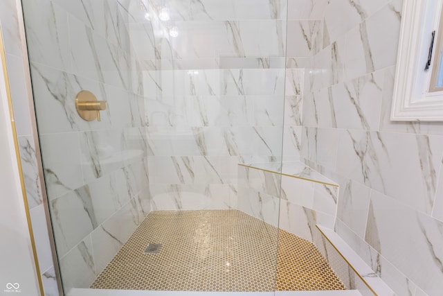 bathroom featuring a tile shower and tile walls