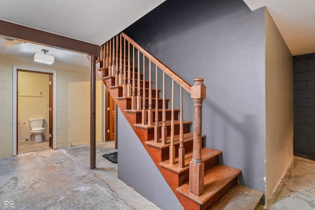 stairway featuring concrete floors