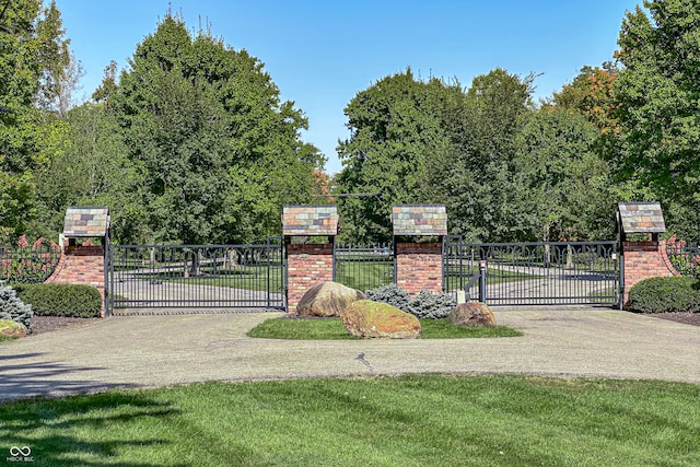 view of gate featuring a yard