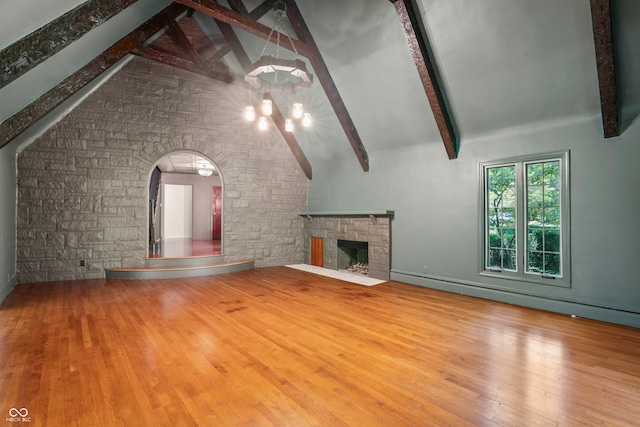 unfurnished living room featuring beamed ceiling, high vaulted ceiling, and hardwood / wood-style flooring