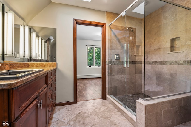 bathroom with an enclosed shower, hardwood / wood-style floors, baseboard heating, and vanity