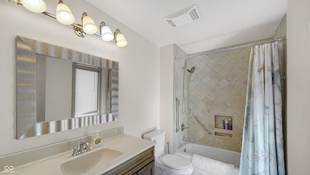 full bathroom featuring vanity, shower / tub combo with curtain, and toilet