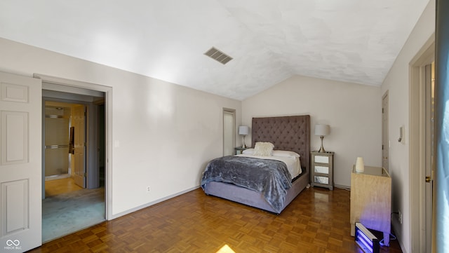 bedroom with lofted ceiling and parquet floors