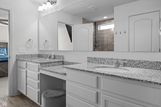 bathroom with vanity, wood-type flooring, and a shower