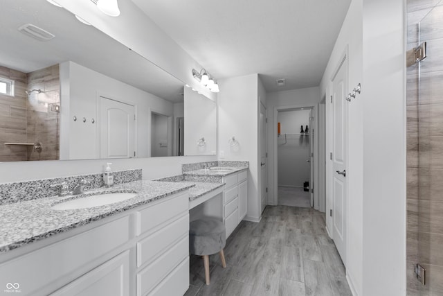 bathroom with vanity, an enclosed shower, and hardwood / wood-style floors