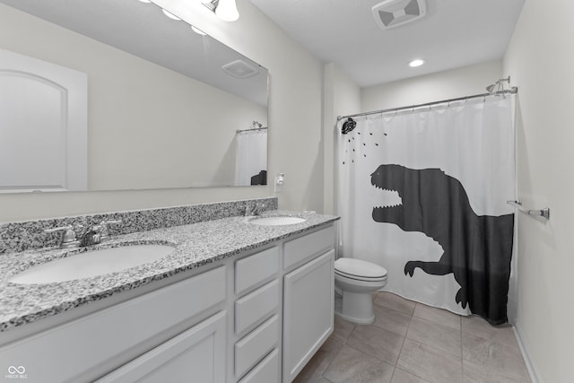 bathroom with vanity, curtained shower, toilet, and tile patterned flooring