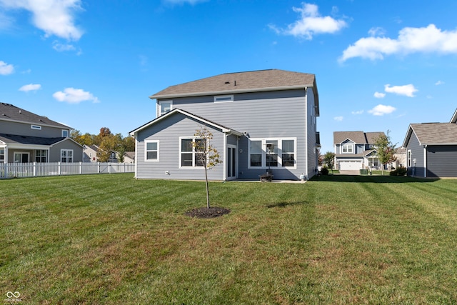 rear view of property with a yard