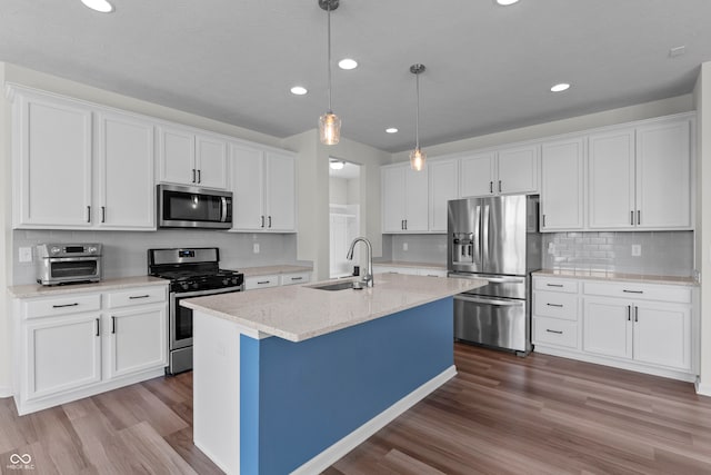 kitchen with white cabinetry, appliances with stainless steel finishes, and sink