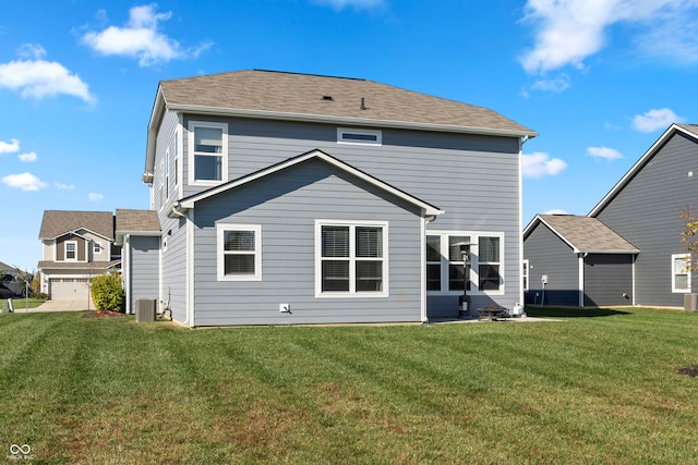 back of house featuring a yard and a garage