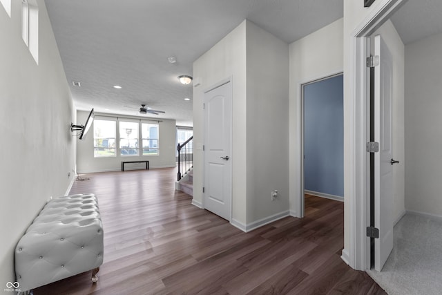 hall with a textured ceiling, hardwood / wood-style flooring, and radiator