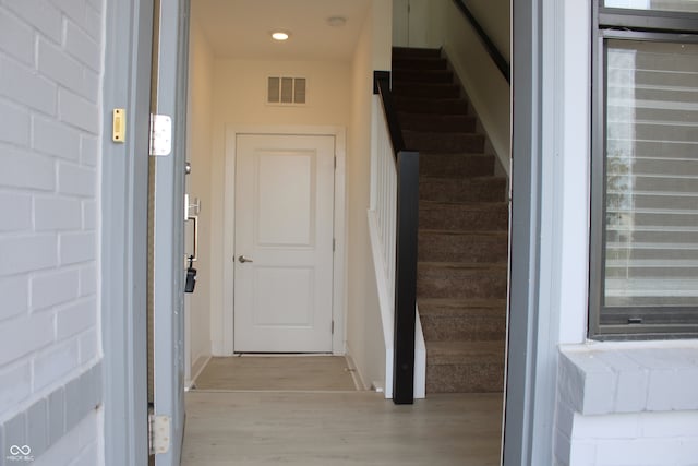 stairs with hardwood / wood-style floors