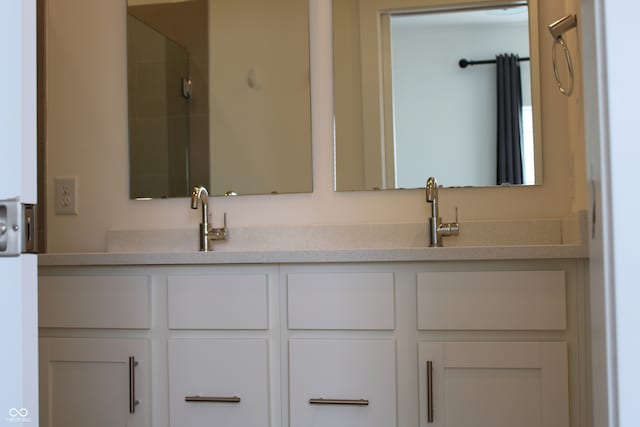 bathroom featuring vanity and a shower with shower door