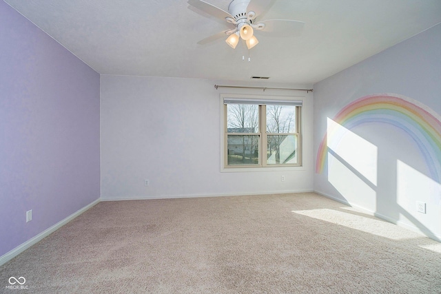 empty room featuring ceiling fan and light colored carpet