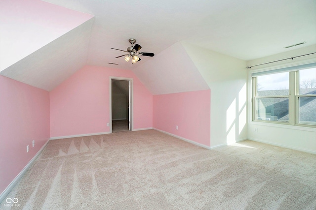 bonus room featuring ceiling fan, light carpet, and vaulted ceiling