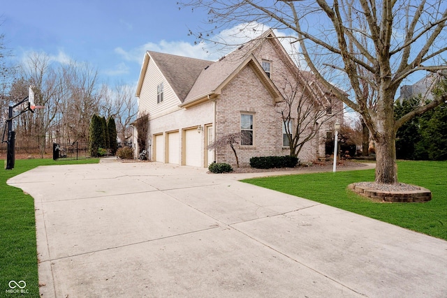 view of side of property with a garage and a lawn