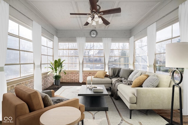 sunroom featuring ceiling fan and a healthy amount of sunlight