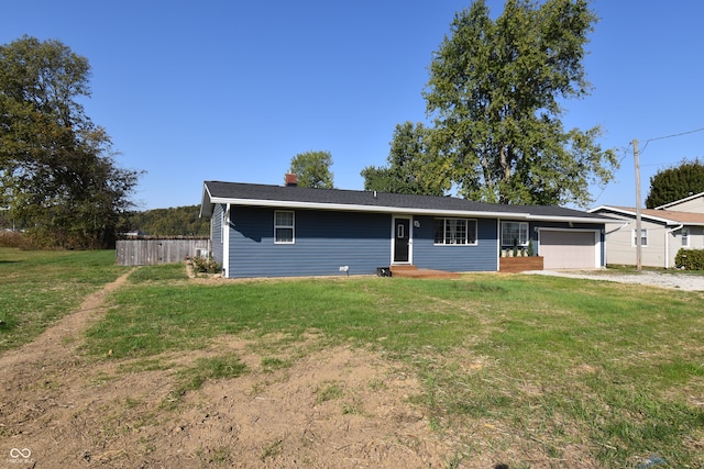 ranch-style home with a garage and a front yard