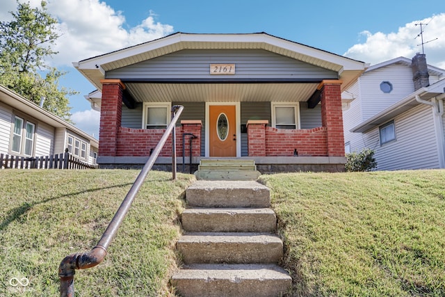 view of front of home featuring a front lawn and a porch