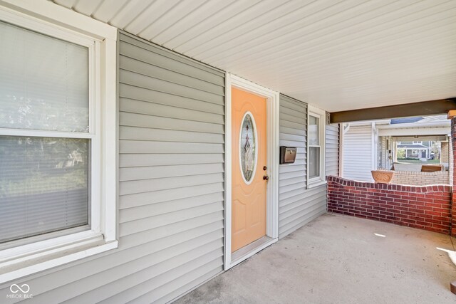 view of exterior entry with covered porch