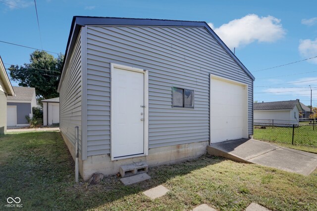 garage featuring a lawn