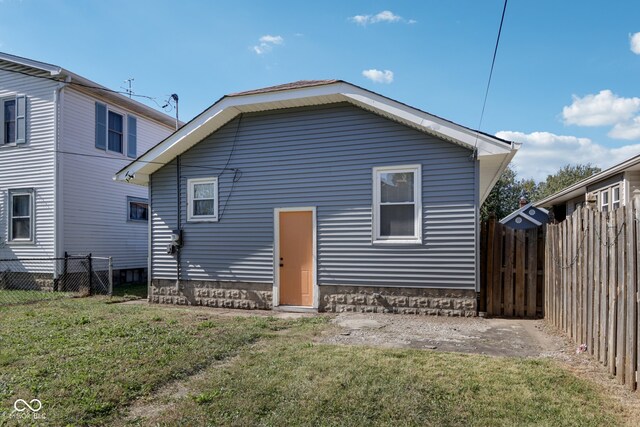 back of house with a lawn