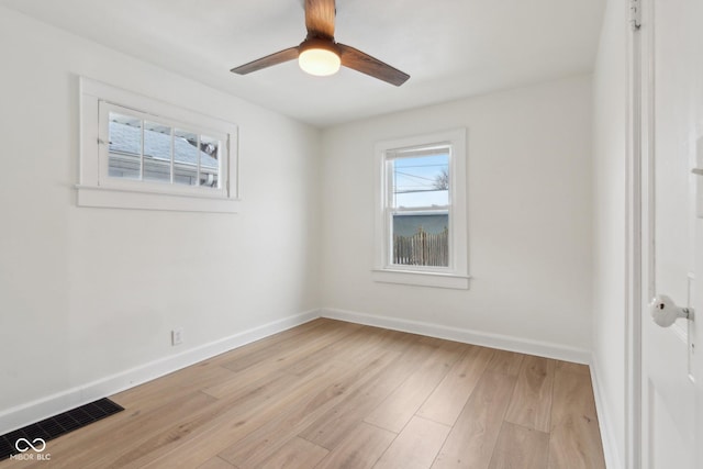 spare room with light wood-type flooring and ceiling fan