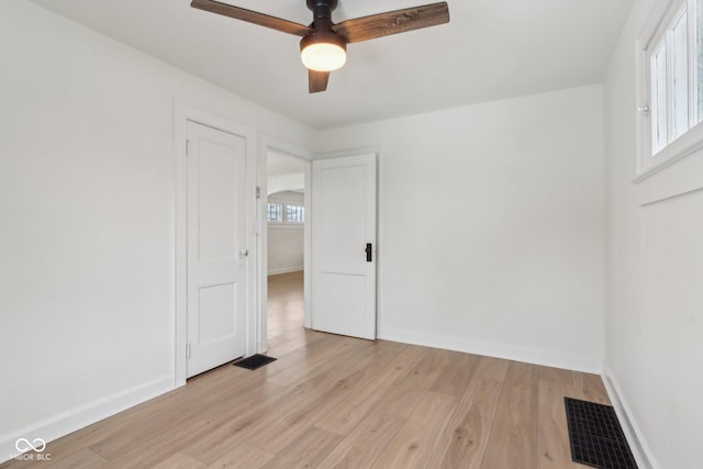 empty room featuring ceiling fan and light hardwood / wood-style flooring