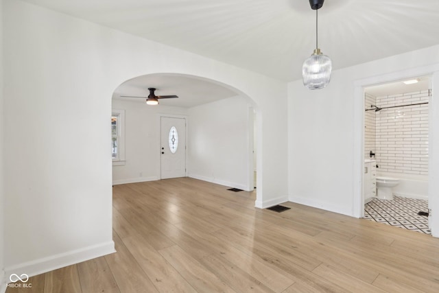 foyer entrance featuring ceiling fan and light wood-type flooring