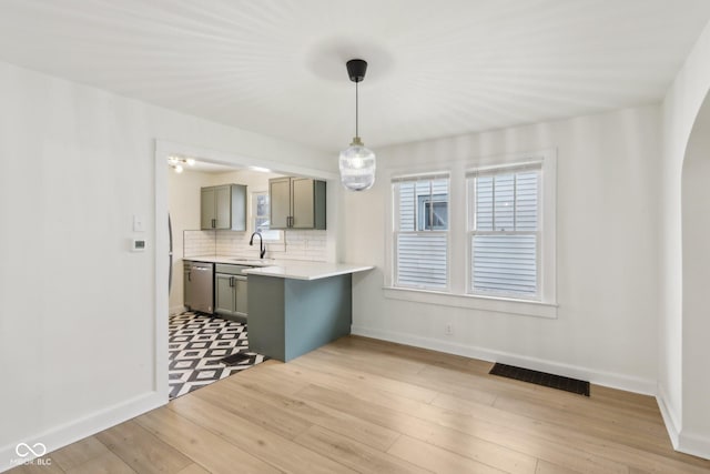 unfurnished dining area with light wood-type flooring and sink