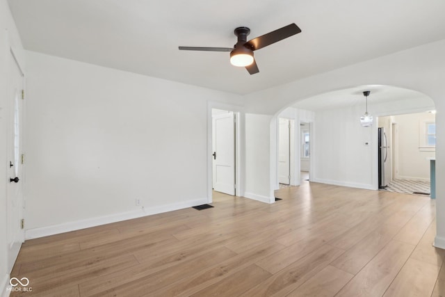 unfurnished living room with ceiling fan and light hardwood / wood-style floors