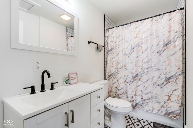 bathroom with toilet, tile patterned floors, vanity, and curtained shower