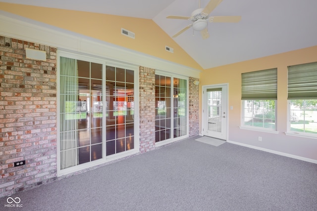 unfurnished sunroom with vaulted ceiling and ceiling fan