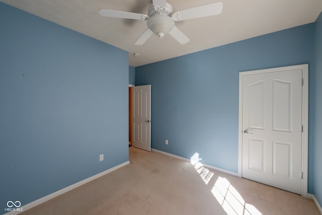 unfurnished bedroom with light colored carpet and ceiling fan