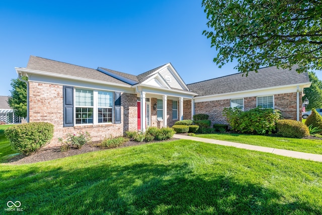 view of front of house with a porch and a front yard