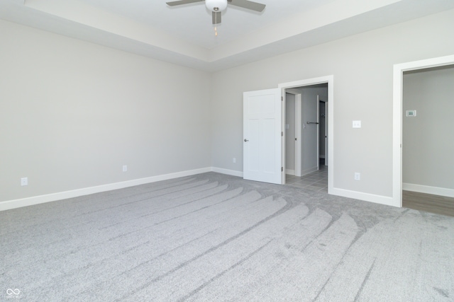 unfurnished bedroom with ceiling fan and light colored carpet