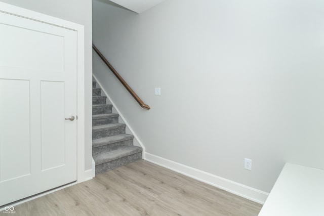 stairs with hardwood / wood-style floors