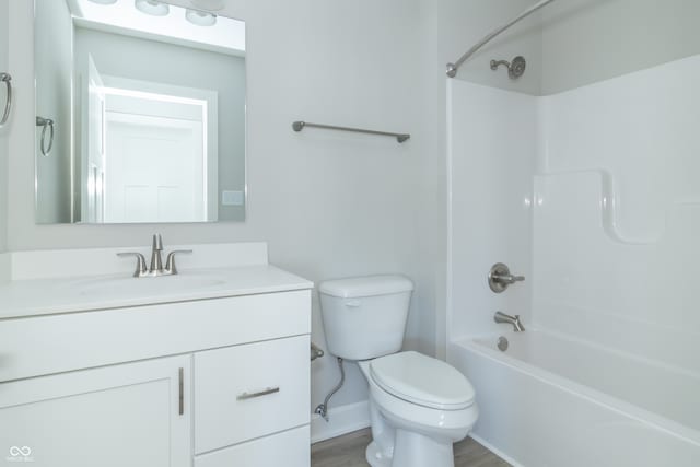 full bathroom with hardwood / wood-style floors, vanity, bathtub / shower combination, and toilet