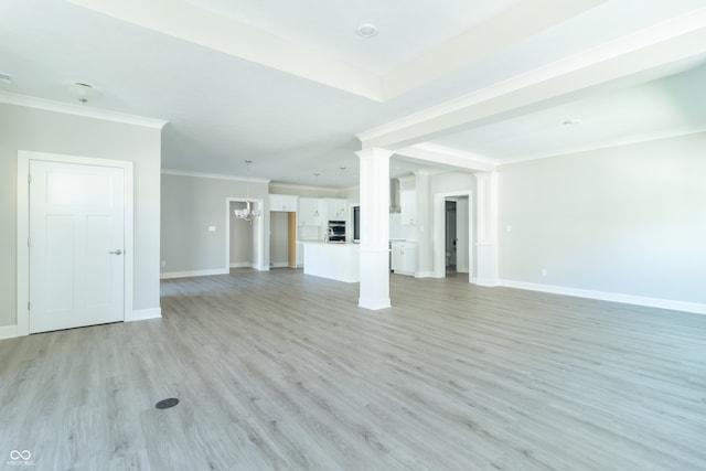 unfurnished living room with ornate columns, light hardwood / wood-style flooring, an inviting chandelier, and ornamental molding